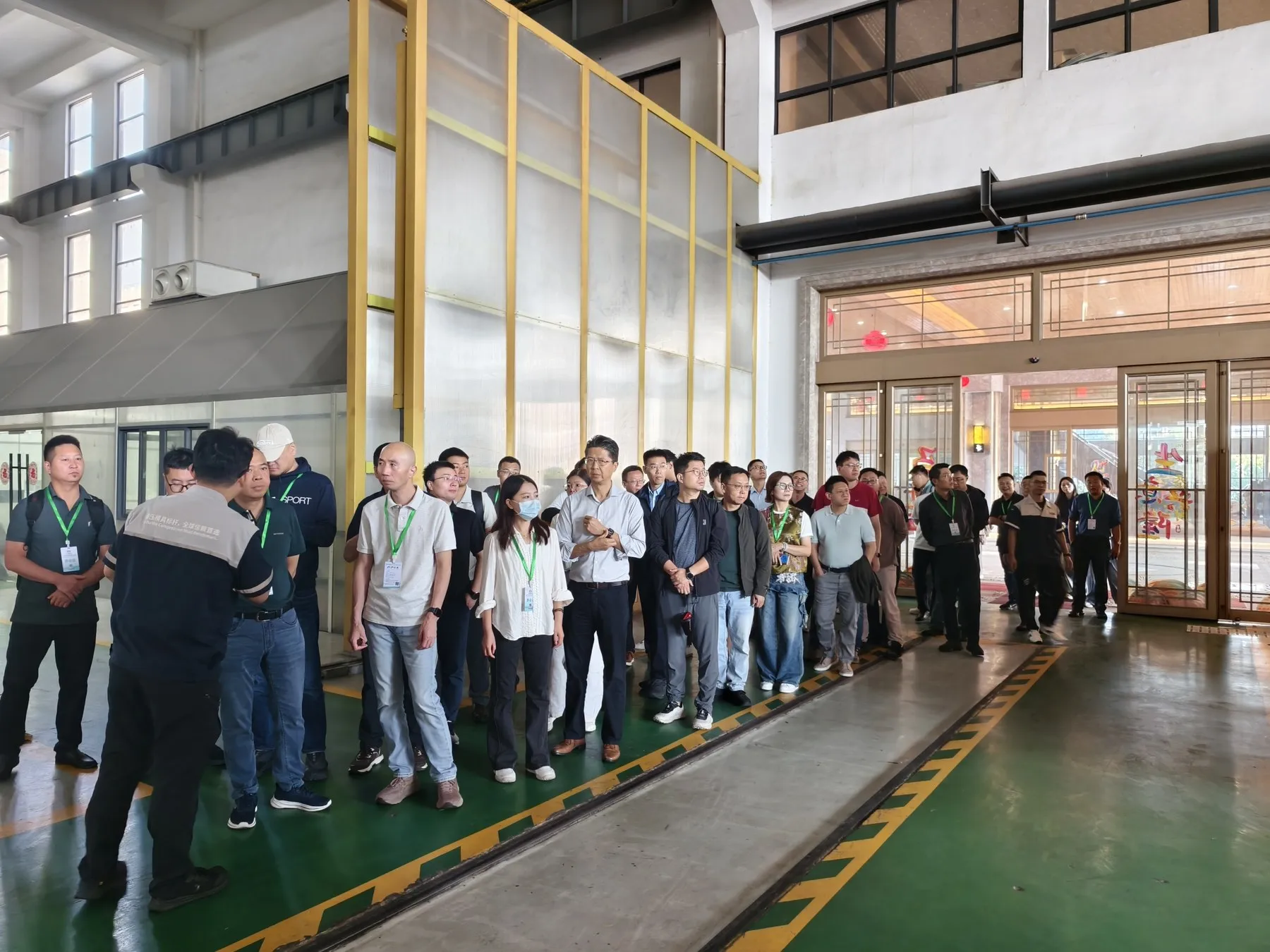 Delegates listening to an introduction during the SUASE factory visit